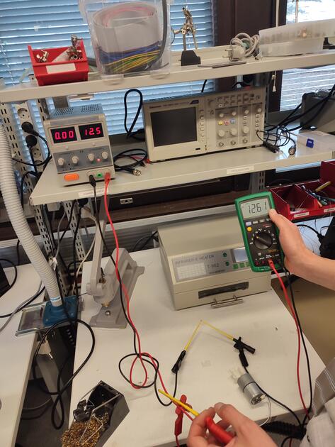 Power supply with motor and multimeter
